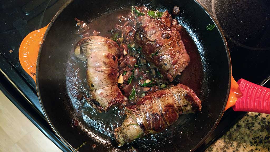 Tender grass fed flank steak stuffed with caramelized onions, mushrooms, and arugula in a rich red wine reduction sauce and seared to perfection.